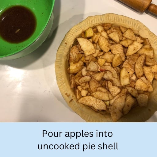Pour apples into uncooked pie shell