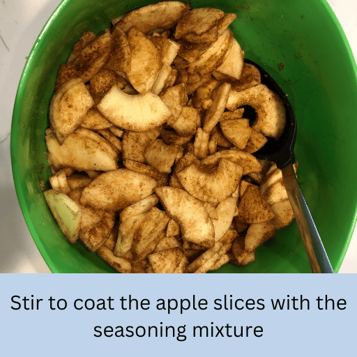 apple sliced coated in cinnamon sugar in a green bowl for gluten and dairy free apple pie