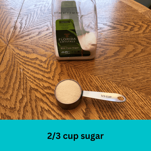 2/3 cup of sugar measured out into a measuring cup